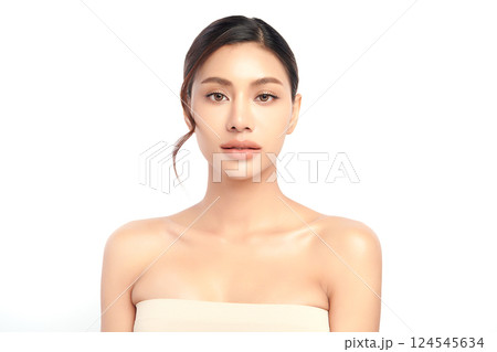 A beautiful young Asian woman with clean, fresh skin against a white background. Skincare, facial treatment, cosmetology, beauty, and spa. An elegant portrait of an Asian woman. 124545634