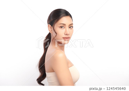 A beautiful young Asian woman with clean, fresh skin against a white background. Skincare, facial treatment, cosmetology, beauty, and spa. An elegant portrait of an Asian woman. A beautiful young Asian woman with clean, fresh skin against a white background. Skincare, facial treatment, cosmetology, beauty, and spa. An elegant portrait of an Asian woman. 124545640