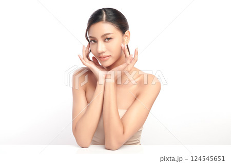 A beautiful young Asian woman with clean, fresh skin against a white background. Skincare, facial treatment, cosmetology, beauty, and spa. An elegant portrait of an Asian woman. A beautiful young Asian woman with clean, fresh skin against a white background. Skincare, facial treatment, cosmetology, beauty, and spa. An elegant portrait of an Asian woman. 124545651