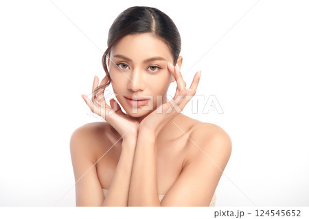A beautiful young Asian woman with clean, fresh skin against a white background. Skincare, facial treatment, cosmetology, beauty, and spa. An elegant portrait of an Asian woman. 124545652
