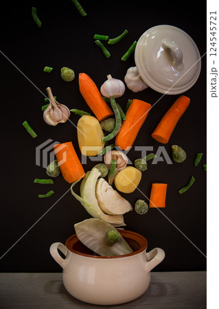 Vegetables in motion before cooking in soup 124545721