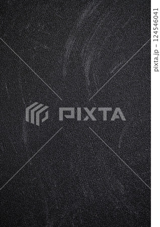 Dark textured surface featuring chalk board residue and scratches, showcasing signs of wear and age, creating a gritty, abstract background Dark textured surface featuring chalk board residue and scratches, showcasing signs of wear and age, creating a gritty, abstract background 124546041