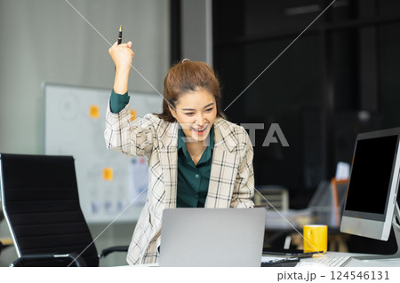 Happy nusinesswoman holding a smartphone and laptop, happy smiling, getting bonus money. Happy nusinesswoman holding a smartphone and laptop, happy smiling, getting bonus money. 124546131