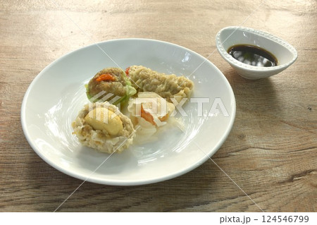 steamed Chinese dumpling Ha Kao stuffing shrimp and cheese with salty egg on plate dipping soy sauce 124546799