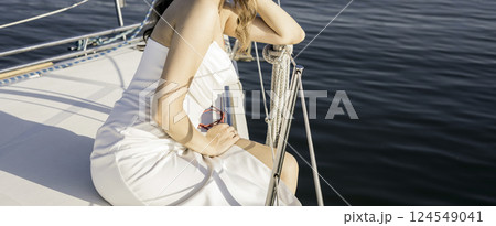 girl sits on a yacht in dress girl sits on a yacht in dress 124549041