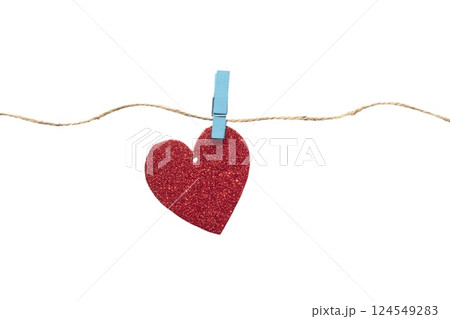 Paper heart with glitter hanging on a rope with a clothespin. Heart isolated on white background 124549283