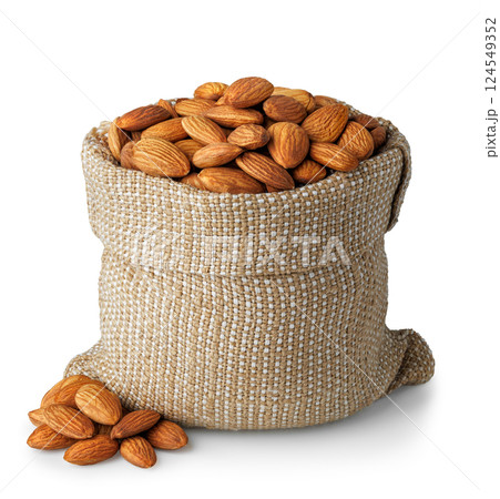 Almond nuts in burlap bag and pile isolated on white background 124549352