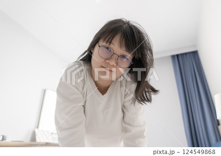 Sexy and cute Japanese, Chinese Thai woman wears white long arm T Shirt on the bed, looks at the camera. Sexy and cute Japanese, Chinese Thai woman wears white long arm T Shirt on the bed, looks at the camera. 124549868
