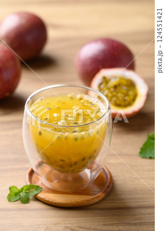 Glass of passion fruit juice with fresh passion fruit on wooden background, Healthy drink 124551421