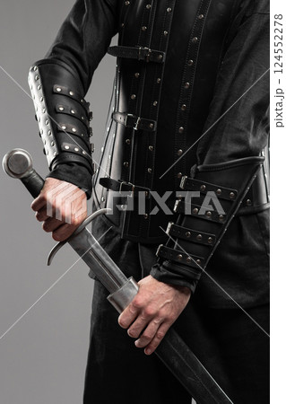 Person Wearing Black Widow Leather Bracers Holding Sword 124552278