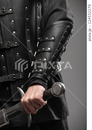 Person Wearing Black Widow Leather Bracers Holding Sword 124552279