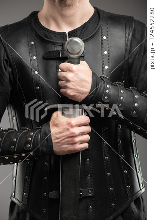 Person Wearing Black Widow Leather Bracers Holding Sword Person Wearing Black Widow Leather Bracers Holding Sword 124552280