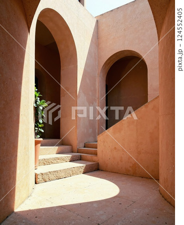 Sunlit mediterranean architecture with arched doorways and staircase 124552405