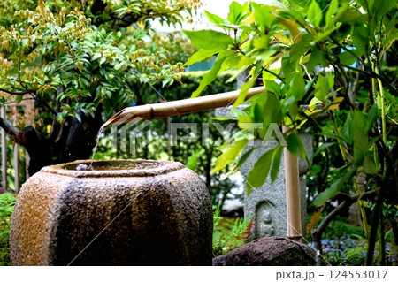 日本庭園の蹲と竹の筧から流れる水 124553017
