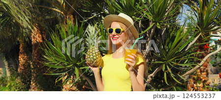 Summer vacation, tourism, happy young woman with pineapple, girl tourist in the park with palm tree Summer vacation, tourism, happy young woman with pineapple, girl tourist in the park with palm tree 124553237