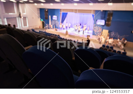 The rehearsal of the play. People in the auditorium are watching the performance. A music concert or festival. Out of focus. High quality photo The rehearsal of the play. People in the auditorium are watching the performance. A music concert or festival. Out of focus. High quality photo 124553357