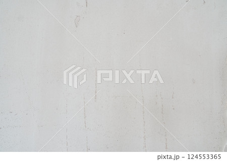 A dirty wall plastered with streaks. The uneven background with the texture of decorative plaster is exposed to atmospheric influences. Rough wall with space for copying. High quality photo A dirty wall plastered with streaks. The uneven background with the texture of decorative plaster is exposed to atmospheric influences. Rough wall with space for copying. High quality photo 124553365
