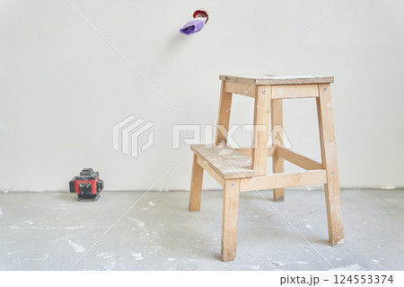 A wooden stand next to the laser equipment. The electrical outlet is unfinished, the wires are rewound with purple electrical tape. There is a place to copy. High quality photo A wooden stand next to the laser equipment. The electrical outlet is unfinished, the wires are rewound with purple electrical tape. There is a place to copy. High quality photo 124553374