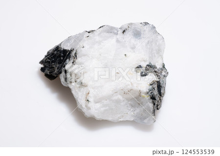 Natural Rough Moonstone Mineral with Black Tourmaline Inclusions, Raw White Gemstone Specimen Isolated on White Background 124553539