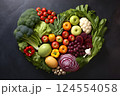 Heart shape made of fresh vegetables on dark background. Healthy food concept. top view 124554058
