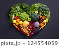 Heart shape made of fresh vegetables on dark background. Healthy food concept. top view 124554059
