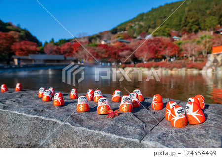 Daruma dolls with maple leaf in autumn of Katsuo-ji temple, Minoh 124554499