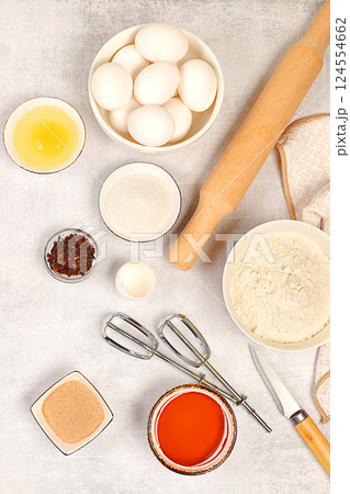 Cooking ingredients for making pie and bread, recipe with eggs, flour, sugar, honey, cinnamon, yeast and butter. Kitchen background of food preparation with space for text. Concept of modern bakery, Cooking ingredients for making pie and bread, recipe with eggs, flour, sugar, honey, cinnamon, yeast and butter. Kitchen background of food preparation with space for text. Concept of modern bakery, 124554662
