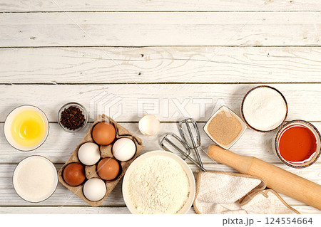 Recipe with eggs, flour, sugar, honey, cinnamon, yeast and butter. Kitchen background of cooking. Culinary ingredients for making pie and bread, Modern bakery concept Recipe with eggs, flour, sugar, honey, cinnamon, yeast and butter. Kitchen background of cooking. Culinary ingredients for making pie and bread, Modern bakery concept 124554664
