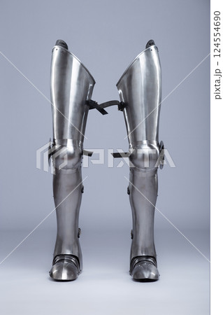 Medieval Steel Greaves for Knights. Full leg metal armor with knee and foot protection, historically used by knights in battle. Medieval Steel Greaves for Knights. Full leg metal armor with knee and foot protection, historically used by knights in battle. 124554690