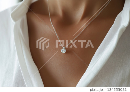 Elegant jewelry closeup featuring a diamond necklace on a delicate chain. Closeup of a diamond necklace on a neck emphasizes sophistication and beauty. Luxury jewelry, white gold and diamonds. 124555081