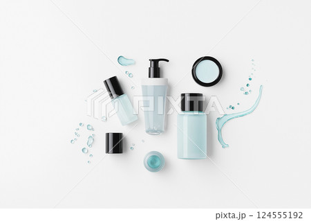 Assorted cosmetic containers on white background with product and packaging variety. A flat lay of various cosmetics and textures on a clean background. Men's cosmetics 124555192