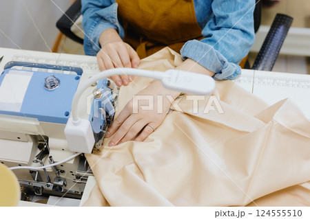 female seamstresses, fashion designers working at sewing machines top view. female seamstresses, fashion designers working at sewing machines top view. 124555510
