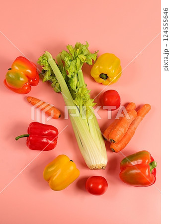 Sweet bell peppers, tomatoes, celery and carrots on a light table. Modern still life of various ripe vegetables for healthy vegetarian food and detox diet, harvest. Advertisement of a store and market Sweet bell peppers, tomatoes, celery and carrots on a light table. Modern still life of various ripe vegetables for healthy vegetarian food and detox diet, harvest. Advertisement of a store and market 124555646