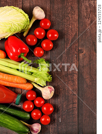Healthy vegan products for healthy lifestyle. Tomatoes, cucumbers, carrots, peppers, broccoli, cabbage, celery and natural juice on wooden background, detox diet and weight loss concept, store Healthy vegan products for healthy lifestyle. Tomatoes, cucumbers, carrots, peppers, broccoli, cabbage, celery and natural juice on wooden background, detox diet and weight loss concept, store 124555728