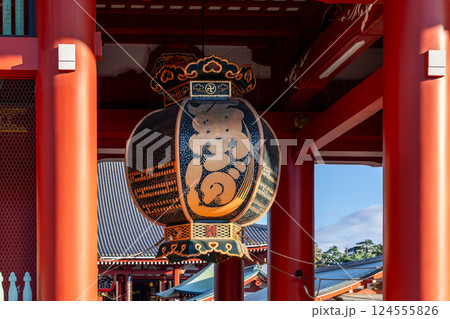 Large gold and black lantern with intricate calligraphy, ornate details hangs entrance of Senso-ji  124555826