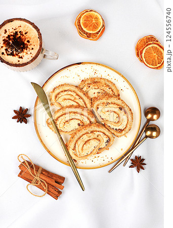 Modern bakery concept, Homemade delicious dessert, sponge cake or roll with sweet jam, cream, nuts and cinnamon and eggnog filling. Festive treat and advertising for cafe and restaurant, selective Modern bakery concept, Homemade delicious dessert, sponge cake or roll with sweet jam, cream, nuts and cinnamon and eggnog filling. Festive treat and advertising for cafe and restaurant, selective 124556740