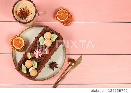 Homemade delicious tiramisu, sponge cake or cake with sweet jam, cream, nuts, cinnamon and milk drink eggnog with cocoa. Concept of modern bakery, festive treat and advertising for cafe and 124556743
