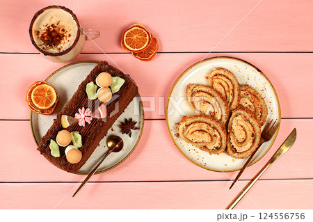 Homemade dessert, stollen or strudel with sweet cream filling, nuts, cinnamon and eggnog. Concept for holiday bakery, seasonal treats and cafe advertising, selective focus Homemade dessert, stollen or strudel with sweet cream filling, nuts, cinnamon and eggnog. Concept for holiday bakery, seasonal treats and cafe advertising, selective focus 124556756