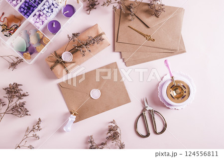 An envelope sealed with wax and a craft kit on the table top view An envelope sealed with wax and a craft kit on the table top view 124556811