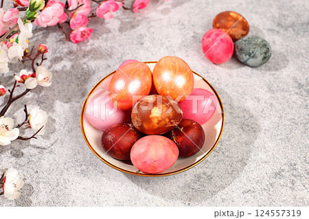 Easter celebration concept, marble easter eggs painted with hibiscus tea and pink matcha on concrete background with sakura branches, easter dish ideas for home cooking. Easter celebration concept, marble easter eggs painted with hibiscus tea and pink matcha on concrete background with sakura branches, easter dish ideas for home cooking. 124557319