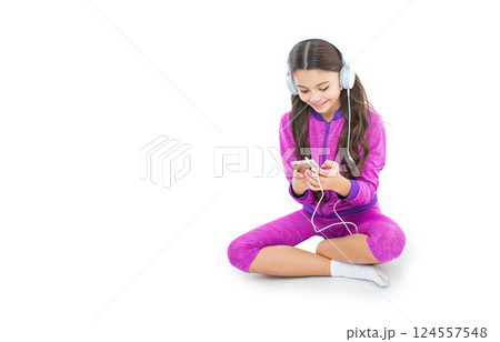 teen girl with music playlist in studio, banner. teen girl choose music playlist on background. teen girl with music playlist in studio, banner. teen girl choose music playlist on background. 124557548