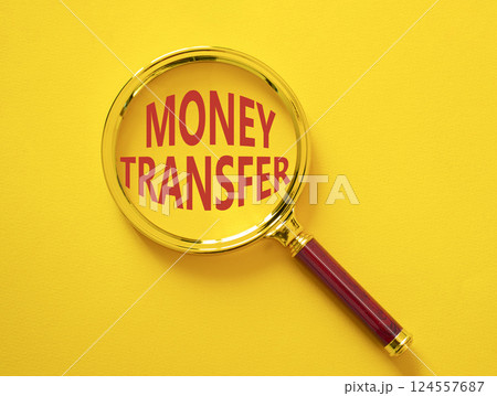 Money Transfer symbol. Magnifying Glass with Concept word Money Transfer. Beautiful yellow background. Business and Money Transfer concept. Copy space Money Transfer symbol. Magnifying Glass with Concept word Money Transfer. Beautiful yellow background. Business and Money Transfer concept. Copy space 124557687