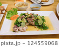 Steamed squid with lemon and spicy thai squid salad with lime and herbs 124559068