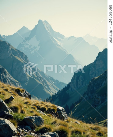 Majestic mountain landscape with lush green valleys and snowy peaks at dusk for nature-themed designs 124559069