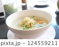 Comforting Congee with Egg and Fresh Toppings in a Cafe Setting 124559211