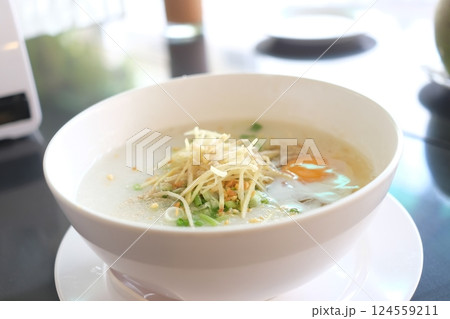 Comforting Congee with Egg and Fresh Toppings in a Cafe Setting 124559211
