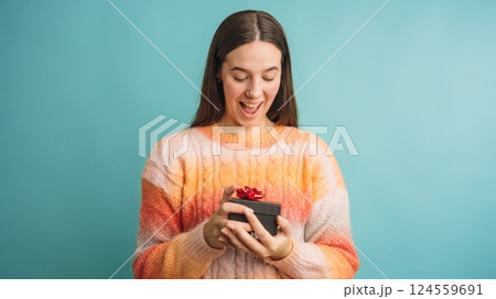 Woman excitedly receiving a gift box present Woman excitedly receiving a gift box present 124559691