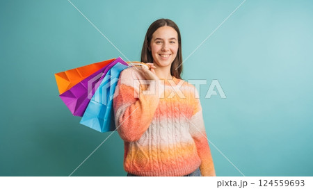 Smiling woman holding colorful shopping bags 124559693