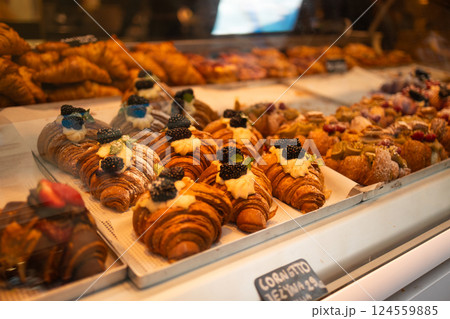 Display of fresh croissants and pastries in a bakery. 124559885
