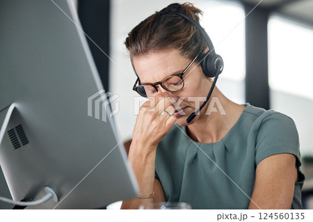 Stress, burnout and call center consultant with a headache while networking for a communications company. Tired, mental health and frustrated telemarketing sales agent with a migraine pain problem 124560135